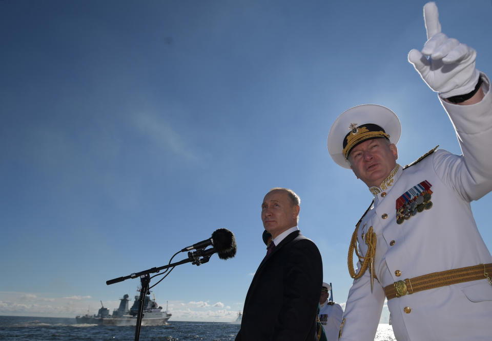 CORRECTS NAME OF COMMANDER-IN-CHIEF - Russian President Vladimir Putin, left, and Commander-in-Chief of the Russian Navy Nikolai Yevmenov arrive to attend the military parade during the Navy Day celebration in St.Petersburg, Russia, Sunday, July 26, 2020. (Alexei Druzhinin, Sputnik, Kremlin Pool Photo via AP)