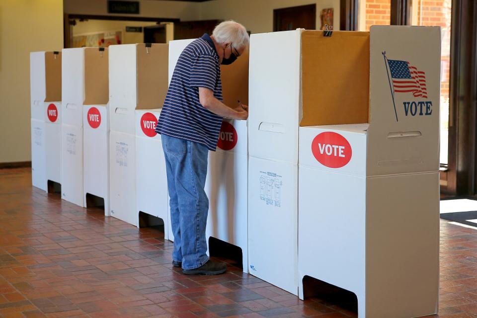 Voter Bruce Spence marks his ballot for an election at St. Augustine of Canterbury Episcopal Church in Oklahoma City on Feb. 8.