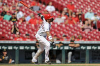 Cincinnati Reds' Nick Castellanos watches his three-run home run during the sixth inning of a baseball game against the Pittsburgh Pirates in Cincinnati, Monday, Sept. 27, 2021. (AP Photo/Aaron Doster)