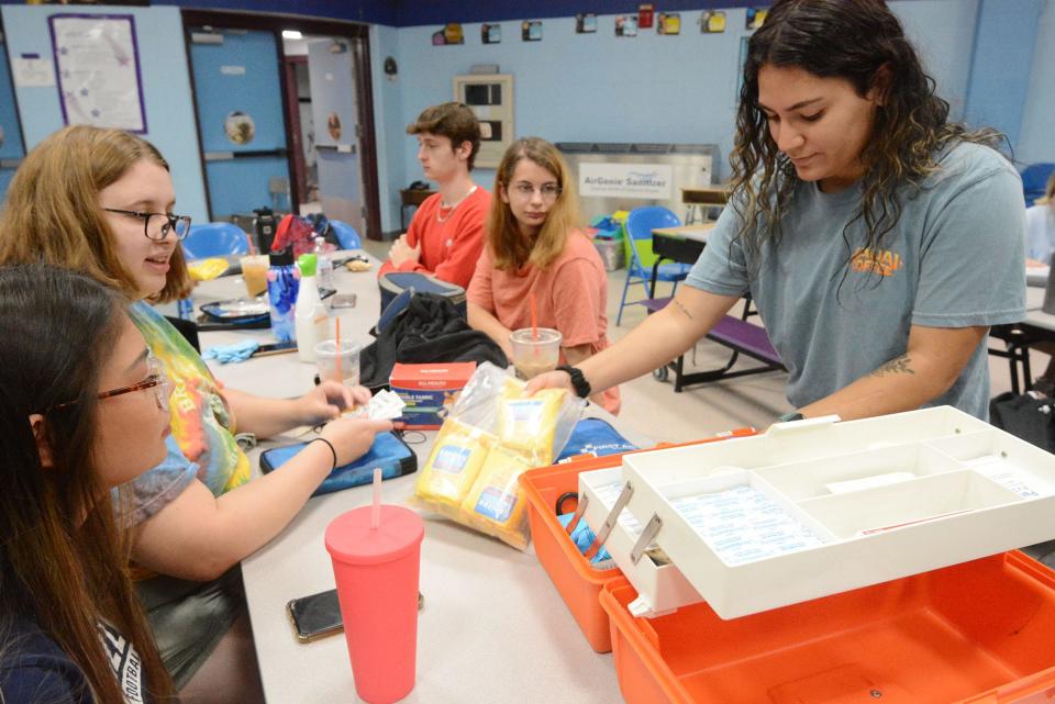 Angel Stewart, 22, of Plainfield, right, and other staff members of the Plainfield Summer Recreation Program, set up a first aid kit for the program at the Shepard Hill Elementary School in Plainfield.