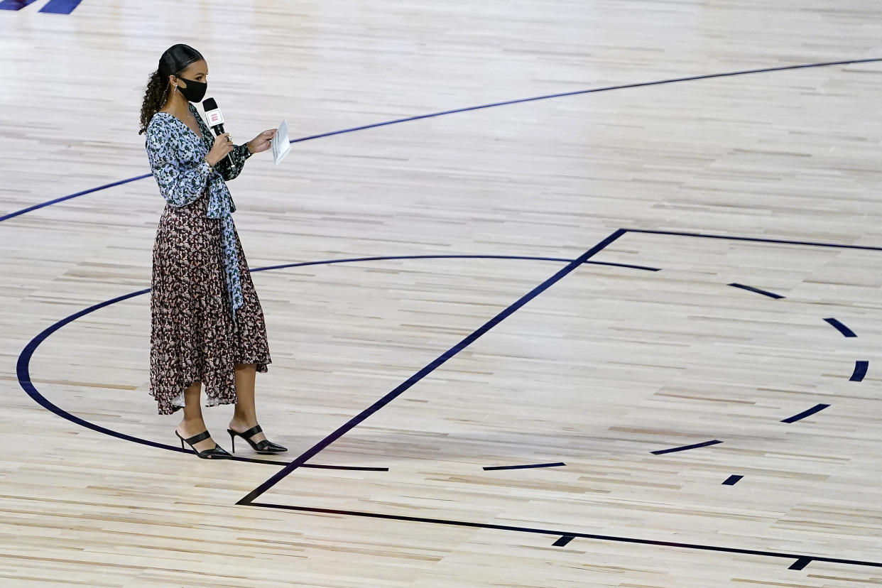 Malika Andrews stands on the court prior to a game.