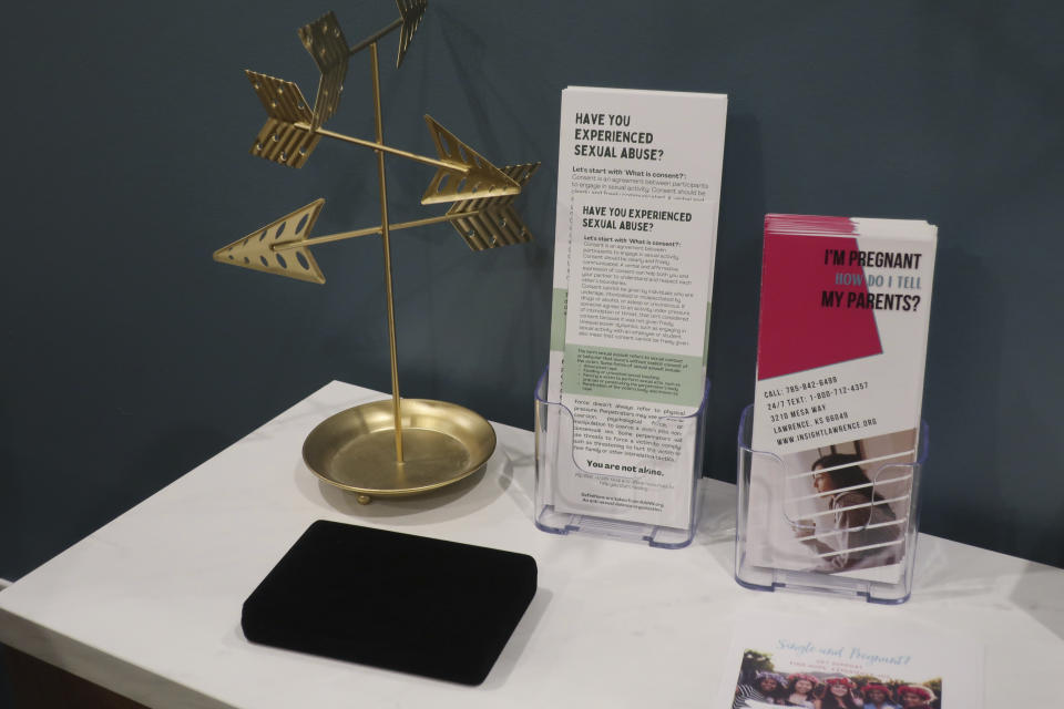 A table in an exam room at the Insight Women's Center holds pamphlets for women who are facing unwanted pregnancies or may be suffering abuse, Tuesday, Jan. 31, 2023, in Lawrence, Kansas. Center staff say in providing services to patients, they deal with women who have been abused or sexually trafficked, and the center has a long-term goal of opening a maternity home to provide shelter. (AP Photo/John Hanna)