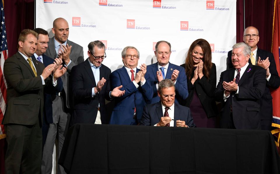 Tennessee Gov. Bill Lee signs the Tennessee Investment in Student Achievement act, Monday, May 2, 2022 in Franklin, Tenn., in the auditorium of his alma mater, Franklin High School.