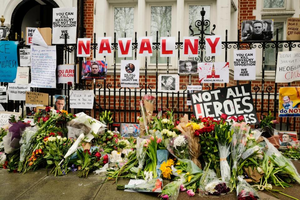 Flowers and tributes are left opposite the Russian embassy, to commemorate the death of Alexei Navalny in London (AP)