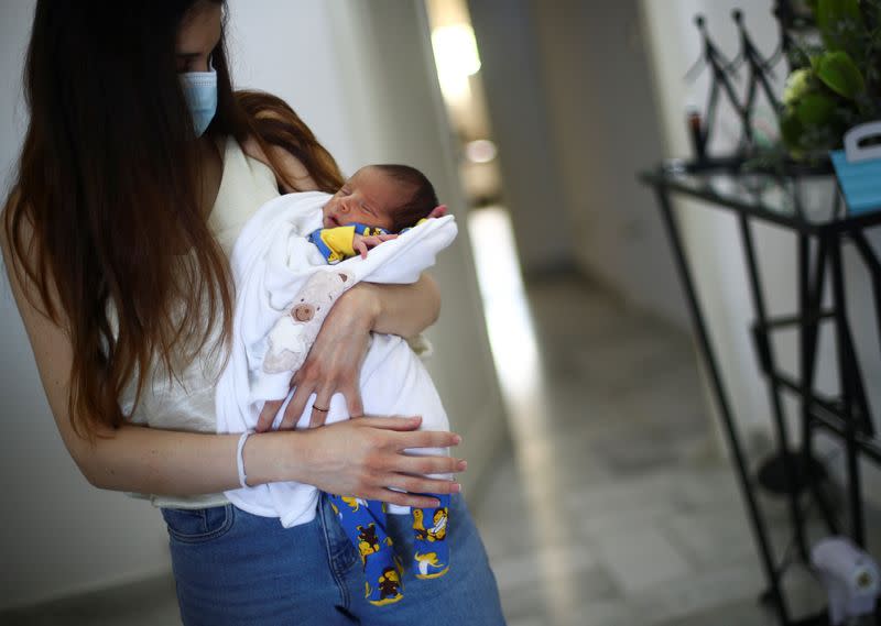 Emmanuelle Lteif Khnaisser, who was in labour at the moment of the Beirut port blast, holds her baby George at the family home in Jal el-Dib