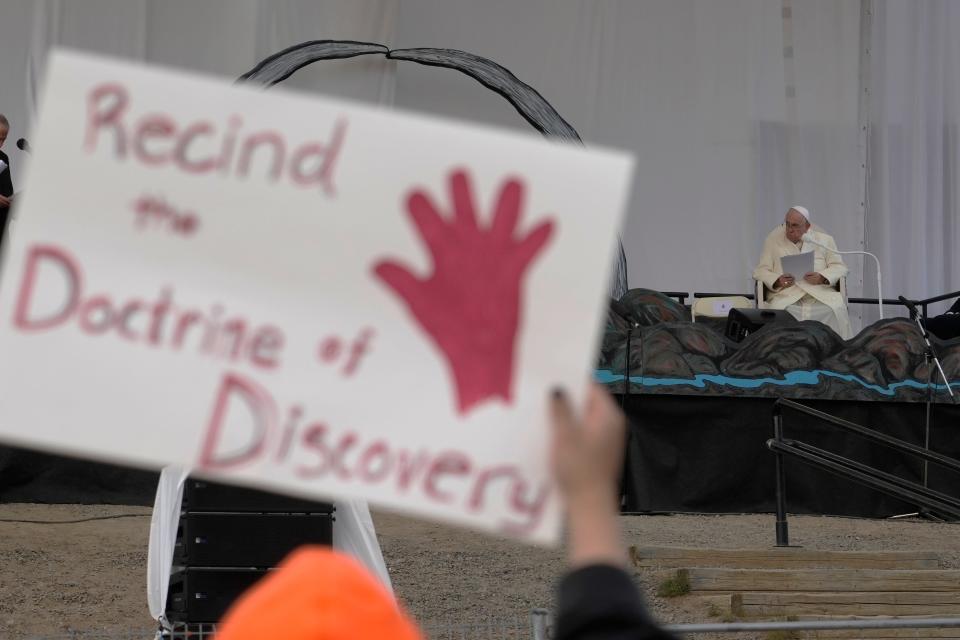 FILE - People protest as Pope Francis meets young people and elders at Nakasuk Elementary School Square in Iqaluit, Canada, Friday, July 29, 2022. The Vatican has on Thursday, March 30, 2023 formally repudiated the “Doctrine of Discovery.” That is the theory backed by 15th century papal bulls that legitimized the colonial-era seizure of Native lands and form the basis of some property law today. (AP Photo/Gregorio Borgia, file)