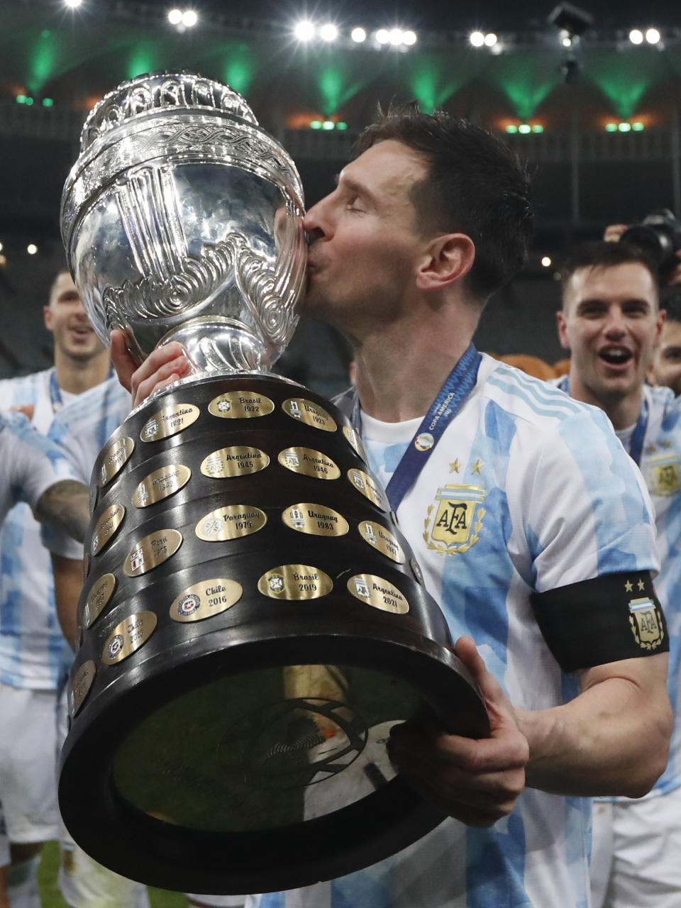 Argentina's Lionel Messi kisses the trophy after beating Brazil 1-0 in the Copa America final soccer match at Maracana stadium in Rio de Janeiro, Brazil, Saturday, July 10, 2021.(AP Photo/Bruna Prado)