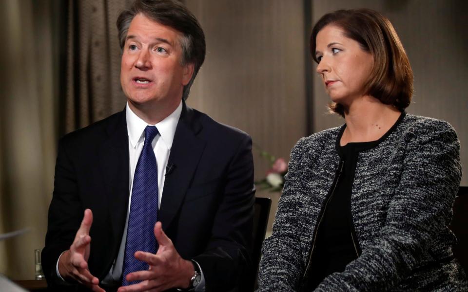 Brett Kavanaugh, with his wife Ashley Estes Kavanaugh, answers questions during a FOX News interview, Monday, Sept. 24, 2018 - AP