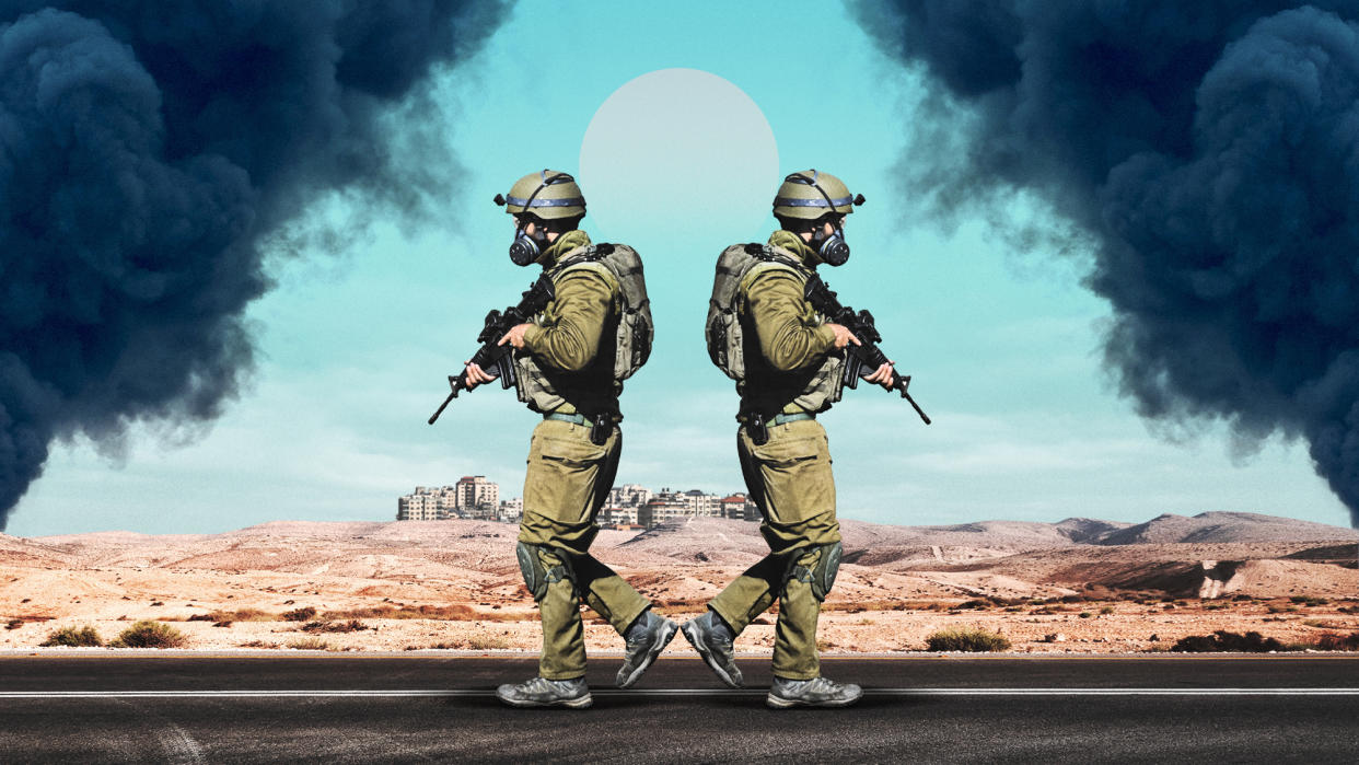  Two IDF soldiers walking in opposite directions towards smoke. 