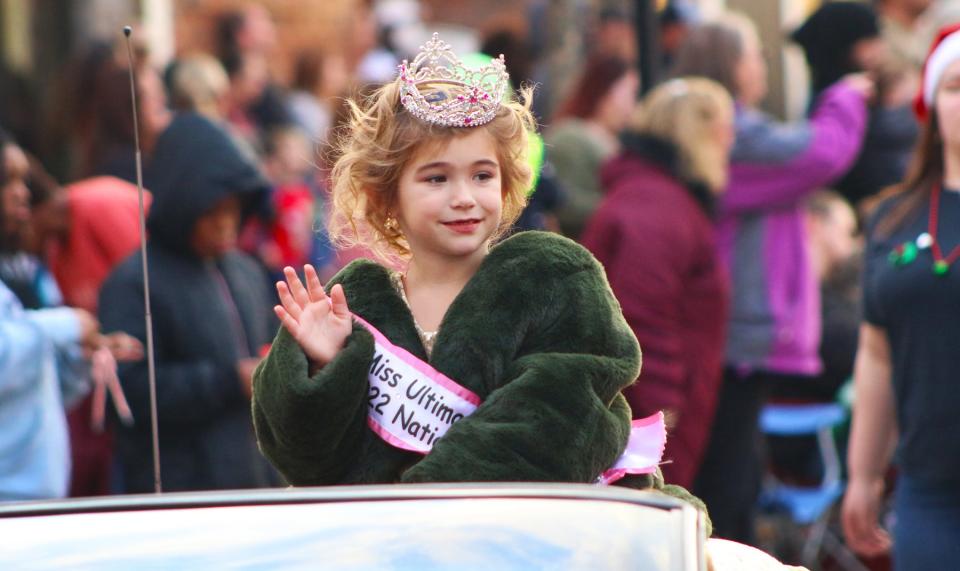 Tiny Miss Ultimate Stars Kinsey Guin waves to the crowd during the Gastonia Christmas parade held Sunday afternoon, Dec. 5, 2021.