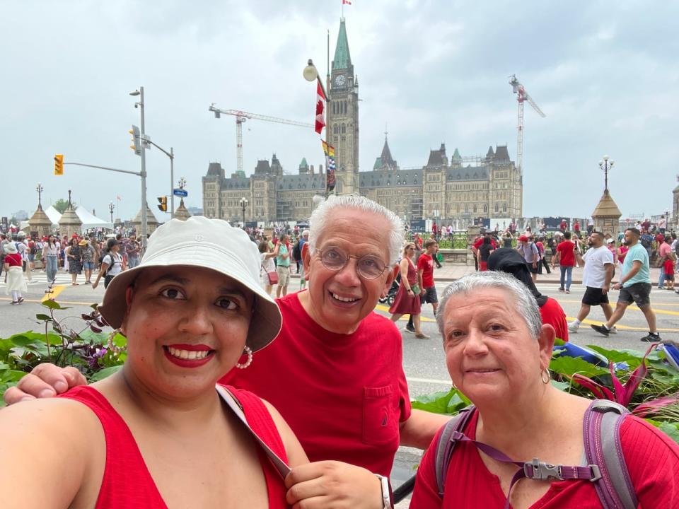 Maxil Platas poses with her parents on Canada day. The process to have them join her permanently in Canada could take up to 50 months, according to the IRCC.