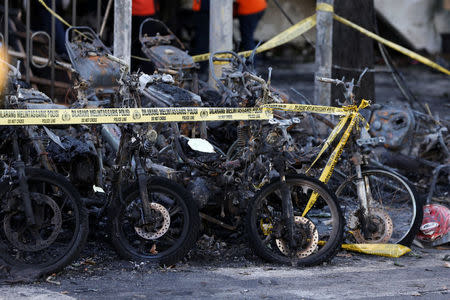 Burned motorcycles are seen following a blast at the Pentecost Church Central Surabaya (GPPS), in Surabaya, Indonesia May 13, 2018. REUTERS/Beawiharta