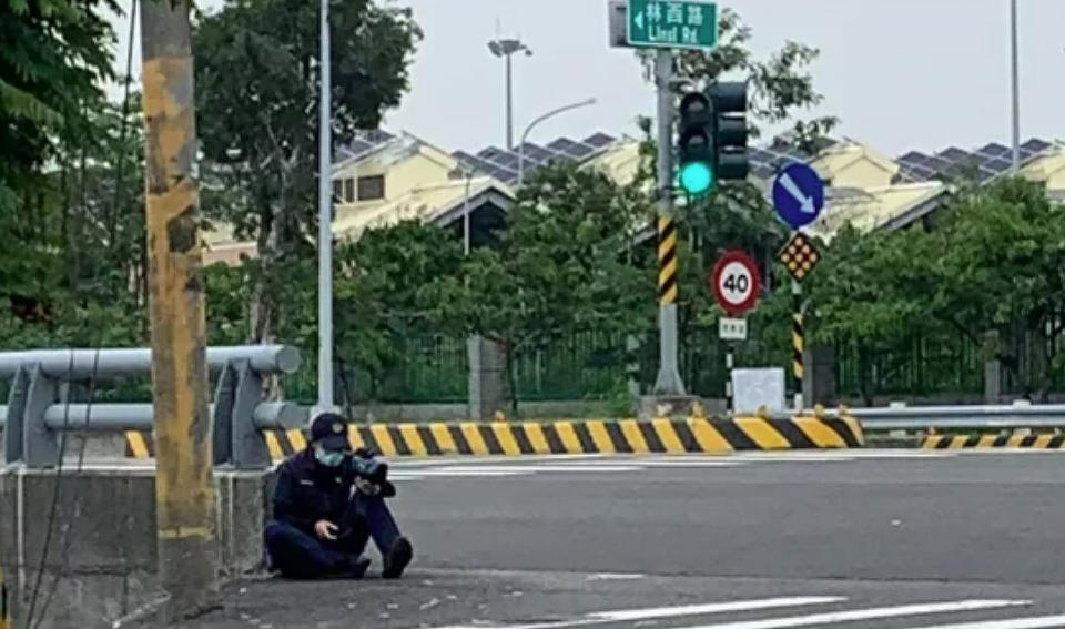 有民眾拍下女警竟蹲坐護欄旁持測速槍抓違規，照片po網引發議論！（圖片翻攝FB/岡山人）