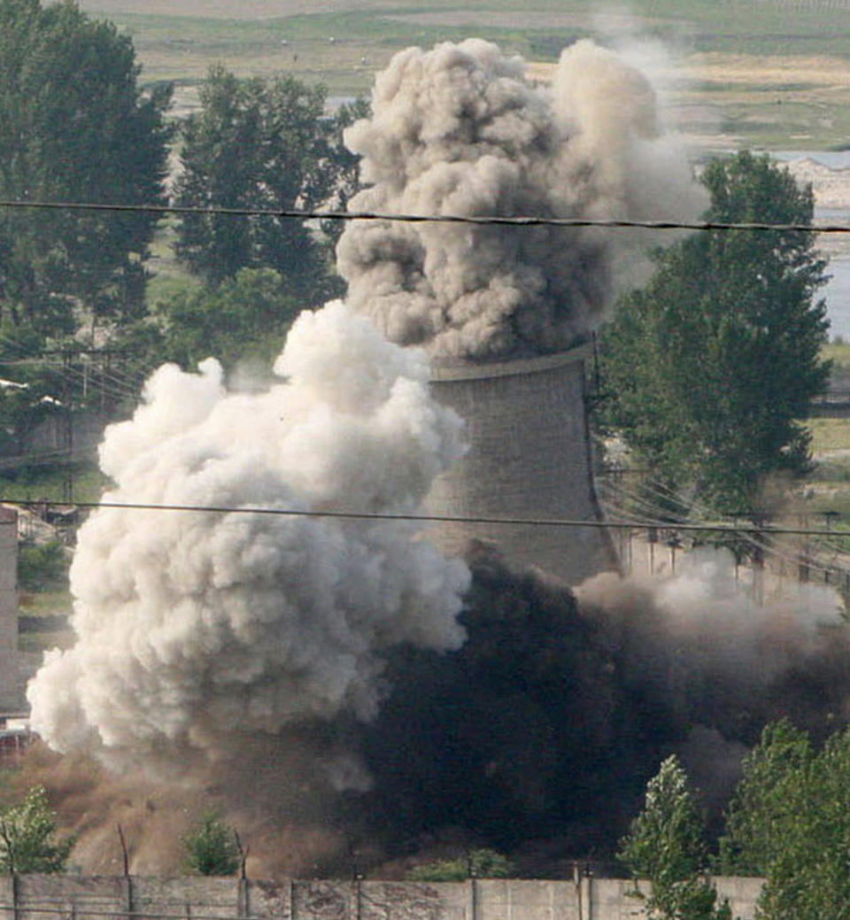 FILE - In this June 27, 2008, file photo released by China's Xinhua News Agency, the cooling tower of the Yongbyon nuclear complex is demolished in Yongbyon, North Korea. The future of the key North Korean nuclear facility is on the table as North Korean leader Kim Jong Un and U.S. President Donald Trump prepare to meet in Vietnam on Feb. 27-28, 2019. The Yongbyon Nuclear Scientific Research Center, the heart of the North’s nuclear development and research, is Kim’s biggest carrot as he tries to win security guarantees and free his country from the U.S.-backed trade sanctions that are hobbling its economy. (Gao Haorong/Xinhua via AP, File)