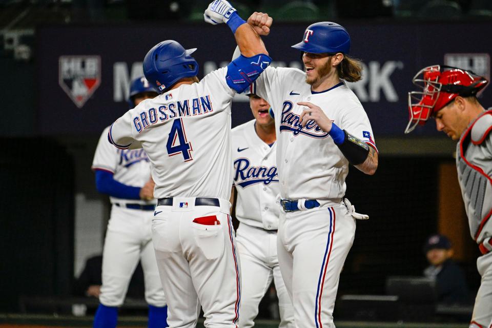 Rangers right fielder (and ex-Tiger) Robbie Grossman and catcher Jonah Heim celebrates after Grossman's home run against the Phillies.