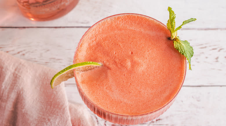 Overhead view of drink with lime slice and mint