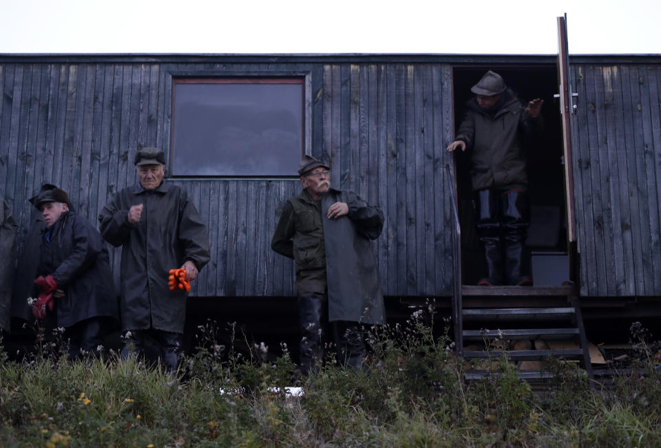 In this picture taken on Thursday, Nov. 15, 2018, fishermen prepare for the traditional fish haul of the Krcin pond near the village of Mazelov, Czech Republic. Czechs will have to pay more for their traditional Christmas delicacy this year after a serious drought devastated the carp population this year. (AP Photo/Petr David Josek)