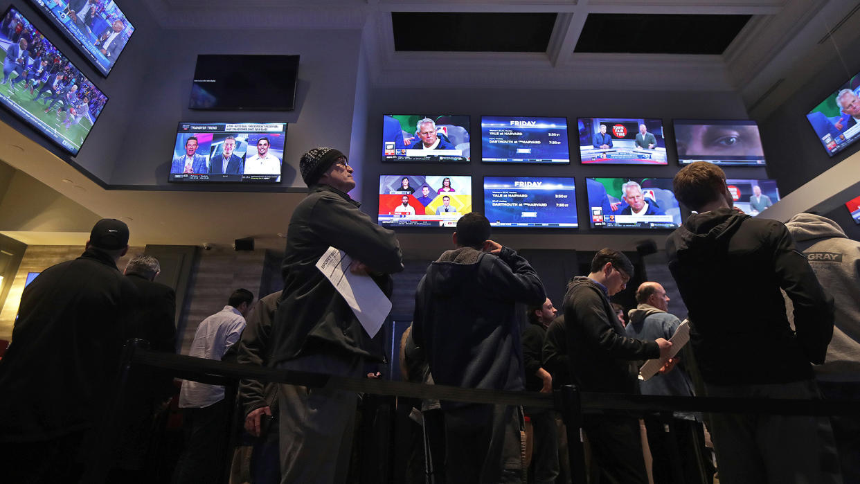 LINCOLN, RI - JANUARY 29: People line up to place bets at the sports book bar at Twin River Casino in Lincoln, RI on Jan. 29, 2019. (Photo by Barry Chin/The Boston Globe via Getty Images)