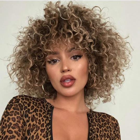 <p>Embrace your natural curls with all things texture. Bangs and lots of layers are the key to mastering this look. </p>