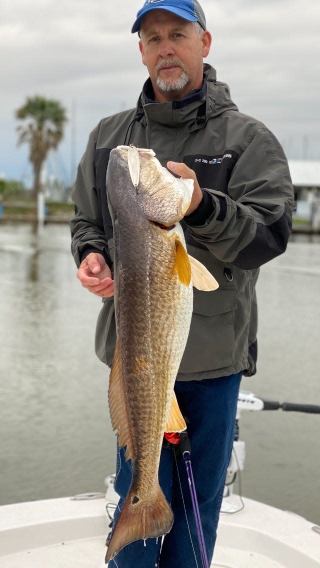 Former Lake Austin fishing guide Jody Jackson holds a red drum he caught in wintertime on a jigging spoon in Texas coastal waters.