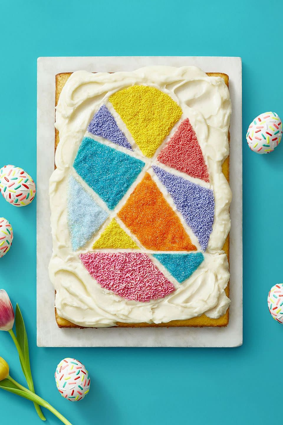 <p>Create an eye-catching mosaic cake with colorful sprinkles, nonpareils, and sanding sugar.</p><p>Get the <strong><a href="https://www.womansday.com/food-recipes/a35681365/vanilla-buttercream-easter-egg-cake-recipe/" rel="nofollow noopener" target="_blank" data-ylk="slk:Vanilla Buttercream Easter Egg Cake recipe.;elm:context_link;itc:0;sec:content-canvas" class="link ">Vanilla Buttercream Easter Egg Cake recipe.</a></strong></p>