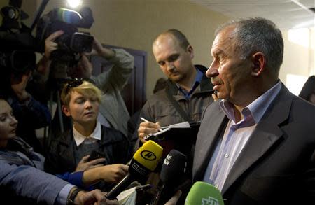 Dmitry Goryachko, the lawyer of CEO of the world's top potash producer Uralkali Vladislav Baumgertner, speaks to the media at a court building in Minsk, September 6, 2013. REUTERS/Vasily Fedosenko