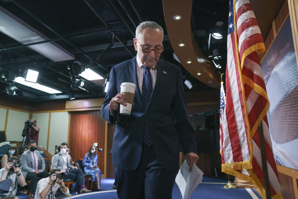 Senate Majority Leader Chuck Schumer, D-N.Y., finishes meeting with reporters after a marathon "vote-a-rama" to advance President Joe Biden's federal priorities, at the Capitol in Washington, Wednesday, Aug. 11, 2021. Keeping a large cup of coffee at hand following the all-night session, the Democratic leader discussed the $3.5 trillion framework for bolstering family services, health, and environment programs, the $1 trillion infrastructure bill, and the importance of voting rights. (AP Photo/J. Scott Applewhite)