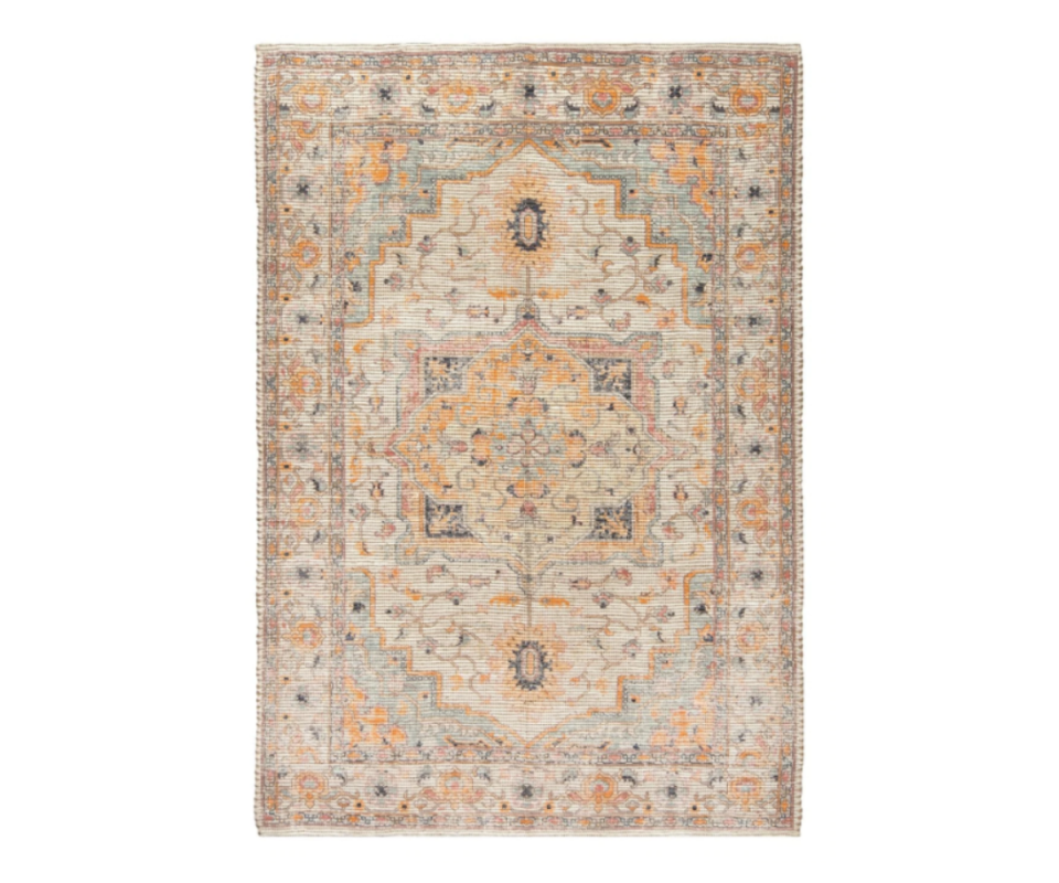 A Persion-inspired rug in muted earthy tones against a white background.