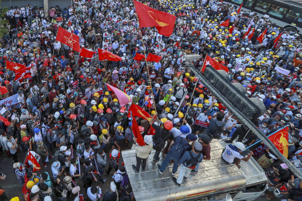 Demonstrator wave flags of the National League for Democracy party during a protest against the military coup in Yangon, Myanmar, Wednesday, Feb. 10, 2021. Protesters continued to gather Wednesday in Yangon breaching Myanmar's new military rulers' decrees that effectively banned peaceful public protests in the country's two biggest cities. (AP Photo)