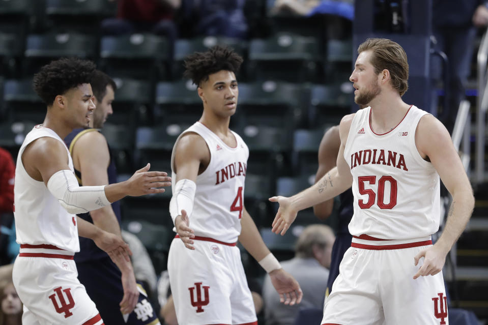 Indiana's Joey Brunk (50) is congratulated by Justin Smith (3) and Trayce Jackson-Davis (4) after Brunk made a shot and was fouled during the first half of an NCAA college basketball game against Notre Dame, Saturday, Dec. 21, 2019. (AP Photo/Darron Cummings)