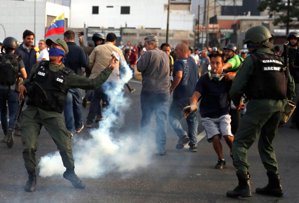 A military member throws a tear gas canister near the Generalisimo Francisco de Miranda Airbase "La Carlota", in Caracas, Venezuela April 30, 2019. (Photo: Carlos Garcia Rawlins/Reuters)