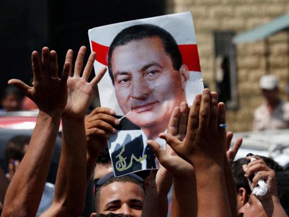 Mubarak supporters outside Tora prison celebrate his release in 2013 (Reuters)