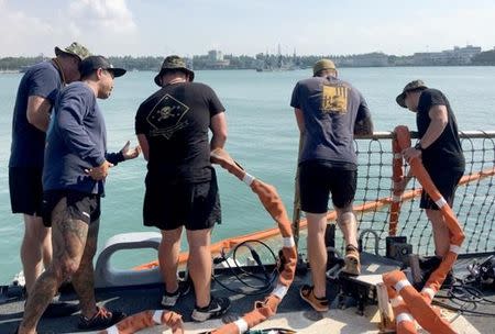 U.S. Navy and Marine Corps divers provide support to the USS John S. McCain (DDG 56) at Changi Naval Base, Singapore August 23, 2017. Master Chief Joshua Dumke/U.S. Navy Handout via REUTERS