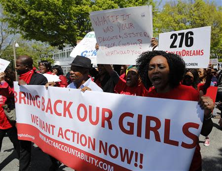 Protesters march in support of the girls kidnapped by members of Boko Haram in front of the Nigerian Embassy in Washington May 6, 2014. REUTERS/Gary Cameron