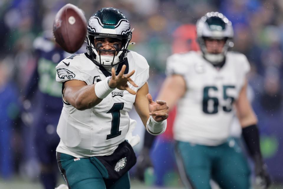 Philadelphia Eagles quarterback Jalen Hurts pitches the ball to tight end Dallas Goedert during the first half of an NFL football game against the Seattle Seahawks, Monday, Dec. 18, 2023, in Seattle.