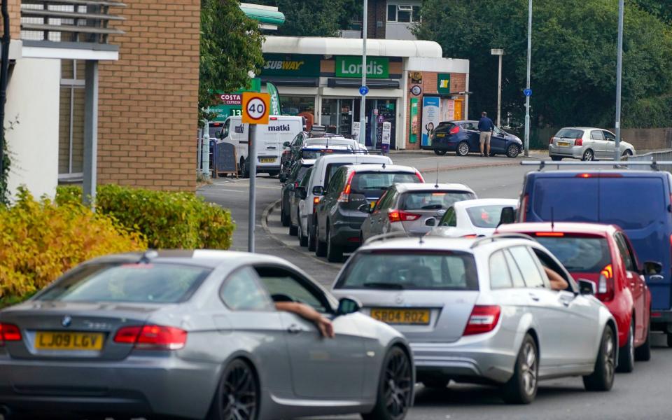 Cars queue for fuel at a BP petrol station in Bracknell, Berkshire - PA