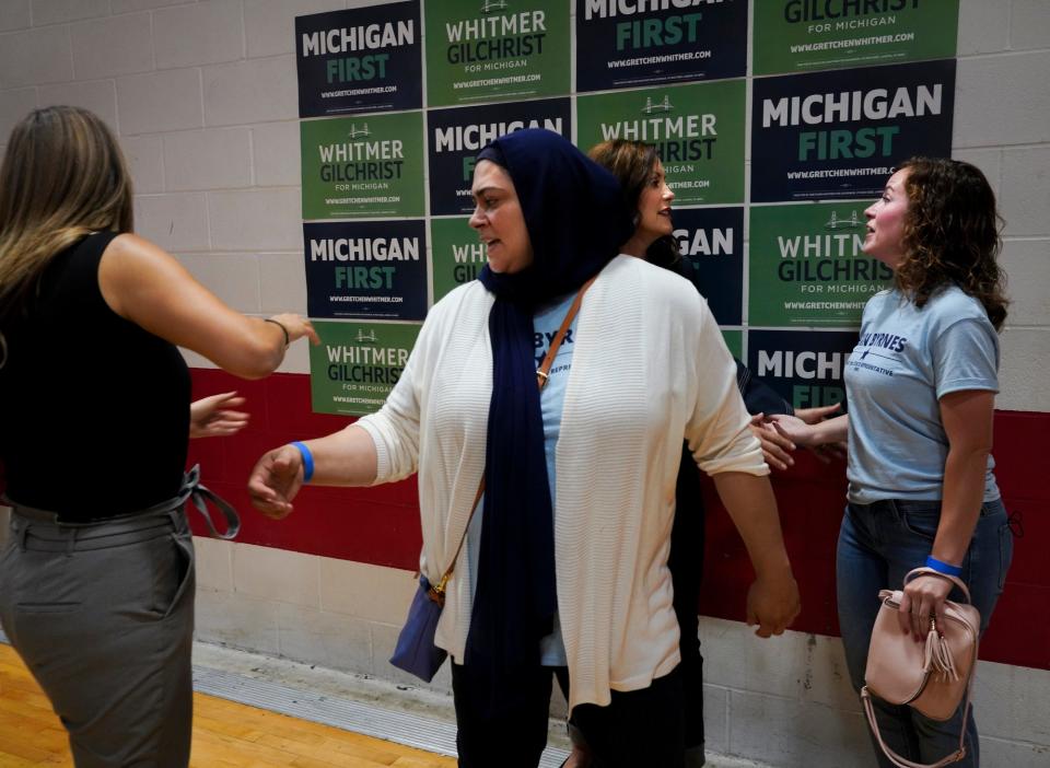 Machhadie Assi, center, moves through a line of people waiting to greet Michigan Gov. Gretchen Whitmer in Dearborn Heights on Sept. 9, 2022. Behind her, the governor shakes hands with Erin Byrnes, who is running for election to the Michigan House of Representatives to represent District 15. Assi works on Byrnes’ campaign. Regional political director for the Whitmer campaign, Claudia Bazzi, is to the left.