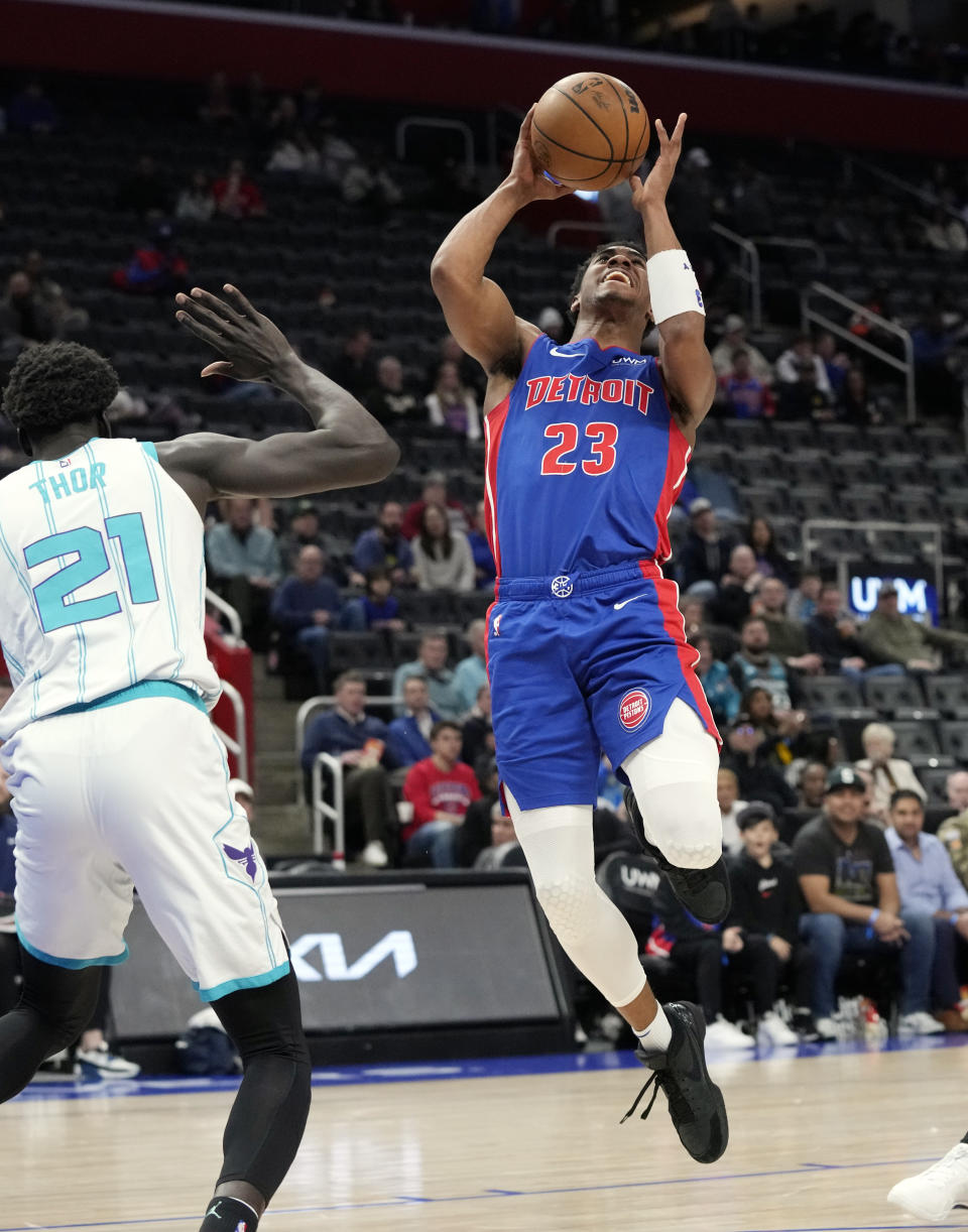 Detroit Pistons guard Jaden Ivey (23) attempts a basket as Charlotte Hornets forward JT Thor (21) defends during the second half of an NBA basketball game, Monday, March 11, 2024, in Detroit. (AP Photo/Carlos Osorio)