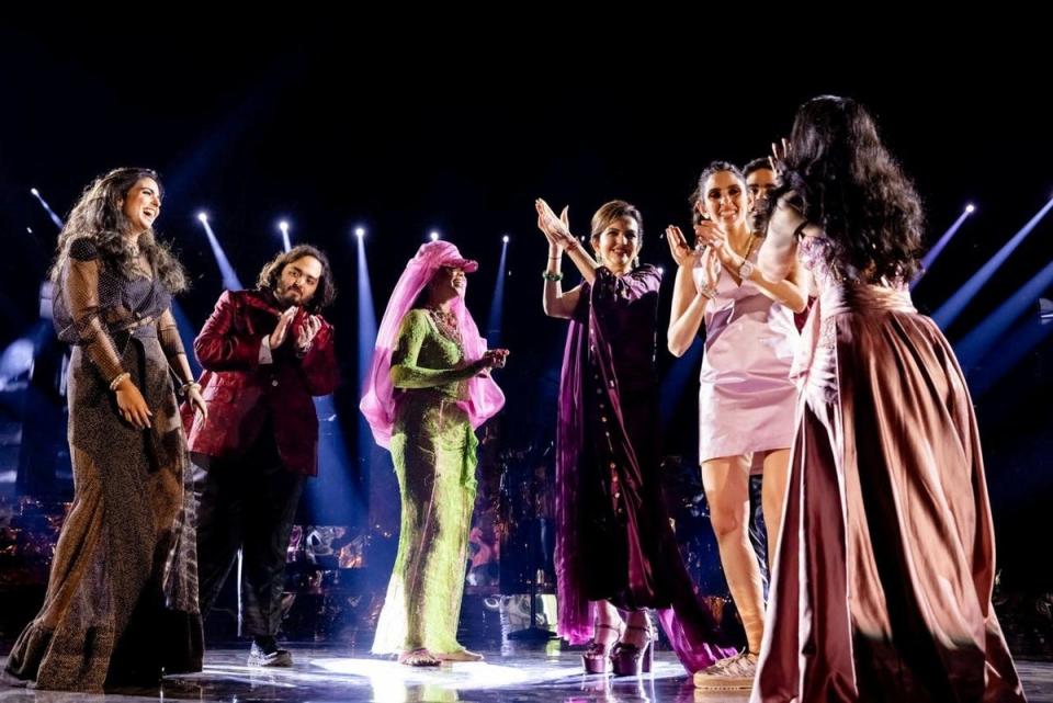 Isha Piramal, Anant Ambani, Rihanna, Nita Ambani, Shloka Mehta Ambani, Akash Ambani and Radhika Merchant react on the stage during pre-wedding celebrations of Anant and Radhika (via REUTERS)