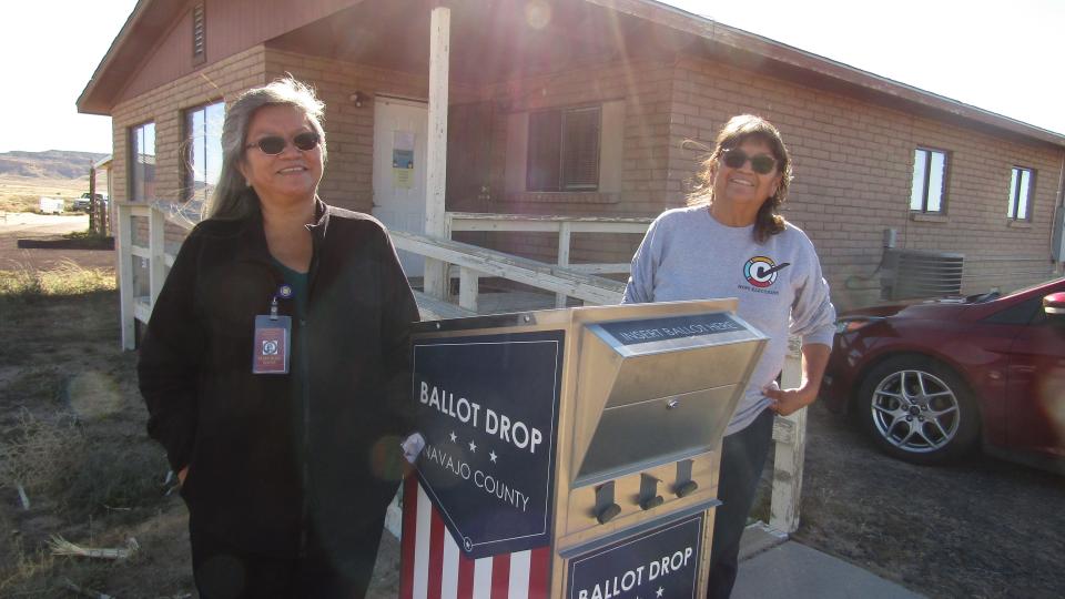 A ballot dropbox in Kykotsmovi on the Hopi Nation with translator Maxine Wadworth (left), and Hopi Elections Registrar Karen Shupla (right).