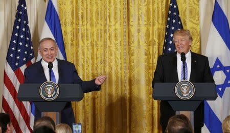 U.S. President Donald Trump (R) laughs with Israeli Prime Minister Benjamin Netanyahu at a joint news conference at the White House in Washington, U.S., February 15, 2017. REUTERS/Kevin Lamarque