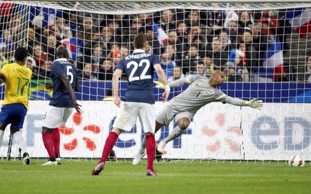 France's Raphael Varane (not pictured) scores against Brazil during their international friendly soccer match at the Stade de France, in Saint-Denis, near Paris, March 26, 2015. REUTERS/Charles Platiau