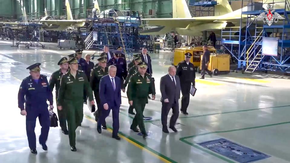 FILE - In this photo taken from video released by Russian Defense Ministry Press Service on Friday, Oct. 6, 2023, Russian Defense Minister Sergei Shoigu, center, visits an aviation plant in Novosibirsk, Russia. Russia has managed to significantly increase the output of its defense industries amid the fighting in Ukraine. (Russian Defense Ministry Press Service via AP, File)