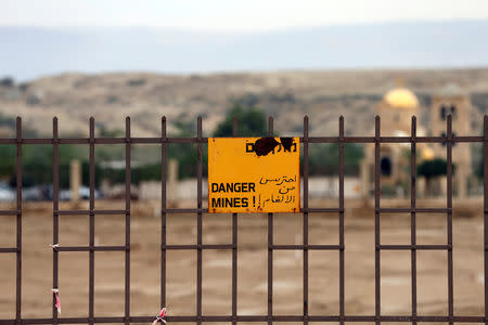 A minefield warning sign is seen in an area recently cleared of mines and unexploded ordnance in a project to clear the area near Qasr Al-Yahud, a traditional baptism site along the Jordan River, near Jericho in the occupied West Bank, December 9, 2018. REUTERS/Ammar Awad