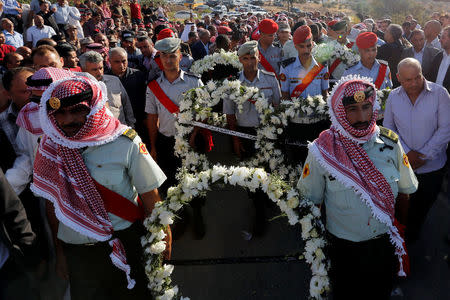 Guard of honor and relatives of Sergeant Hisham Aqarbeh, of the anti-terrorist unit, who was killed during an attack yesterday, attend his funeral in Birayn in the city of Zarqa, Jordan, August 12, 2018.REUTERS/Muhammad Hamed