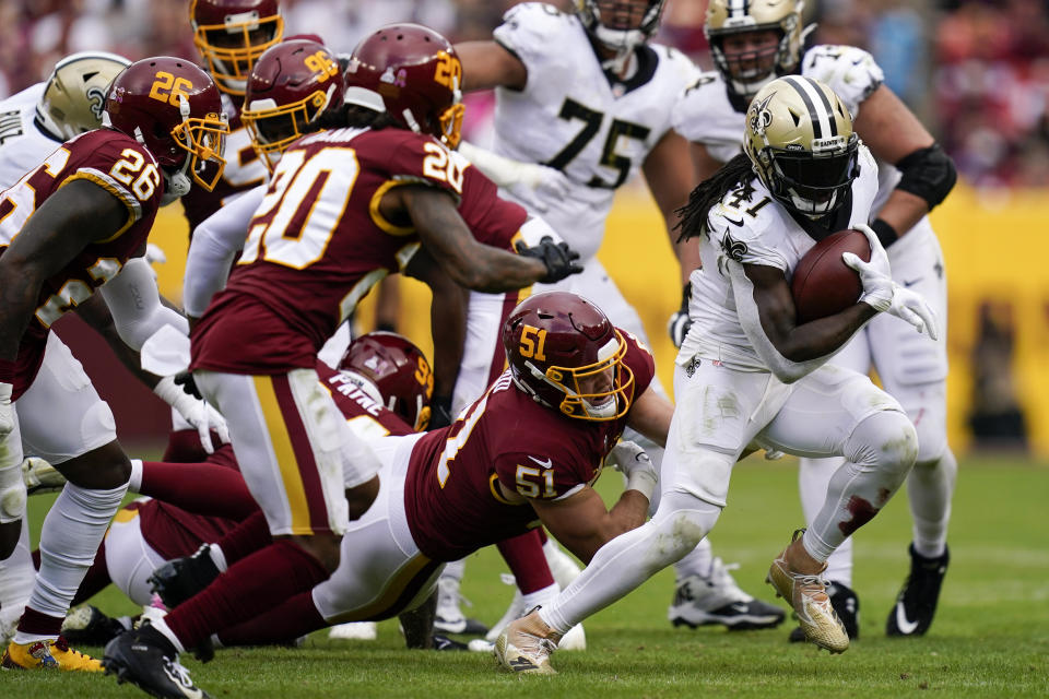 New Orleans Saints running back Alvin Kamara, right, rushes the ball in the second half of an NFL football game against the Washington Football Team, Sunday, Oct. 10, 2021, in Landover, Md. (AP Photo/Al Drago)