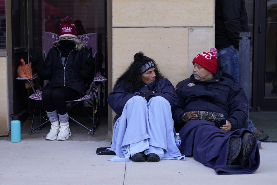 Supporters wait to enter a former President Donald Trump commit to caucus rally, Sunday, Oct. 29, 2023, in Sioux City, Iowa. (AP Photo/Charlie Neibergall)