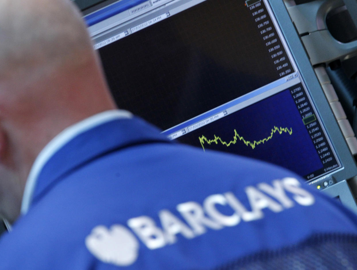 A Barclay's trader works on the floor of the New York Stock Exchange, July 3, 2012. REUTERS/Brendan McDermid (UNITED STATES - Tags: BUSINESS)