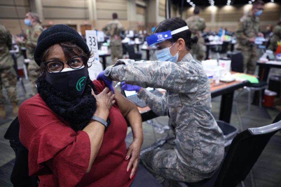 Serena Nicholas of the Illinois air national guard administers a Covid-19 vaccine to Larcetta Linear at a mass vaccination center in Tinley Park, Illinois, in January 2021.