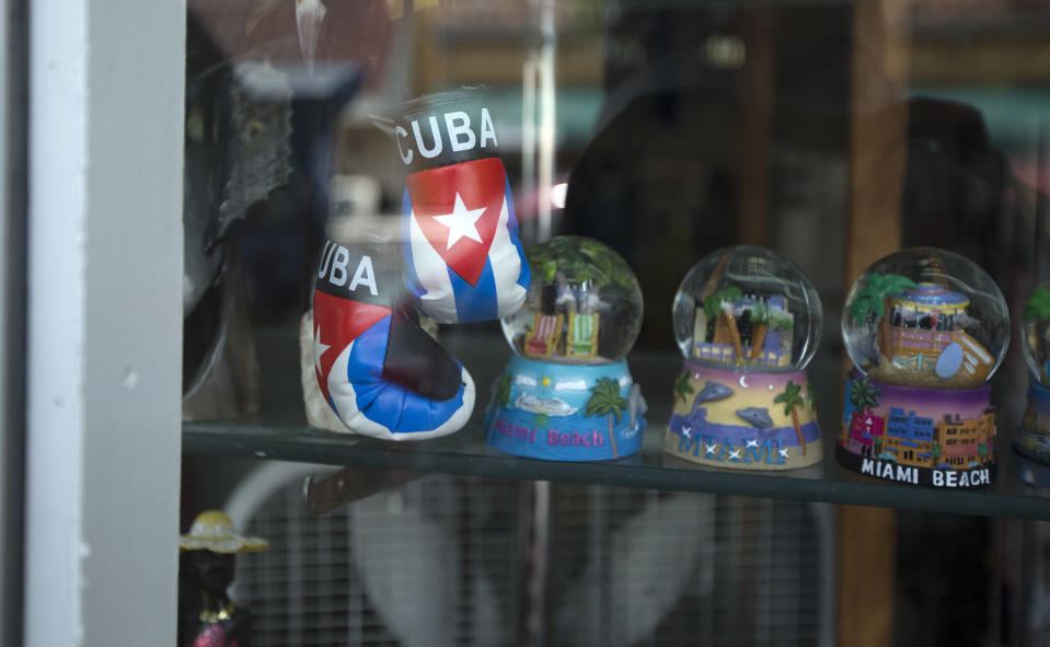 This April 30, 2014 photo shows souvenirs displayed in a gift shop on "Calle Ocho" (Eighth Street) in MIami's Little Havana. Once a refuge for Cuban exiles rekindling the tastes and sounds a lost home, today Miami’s Little Havana is a mosaic of cultures and a popular tourist destination. (AP Photo/J Pat Carter)